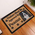 Border Collie entryway doormat displayed on a wood floor beside a white door and houseplant