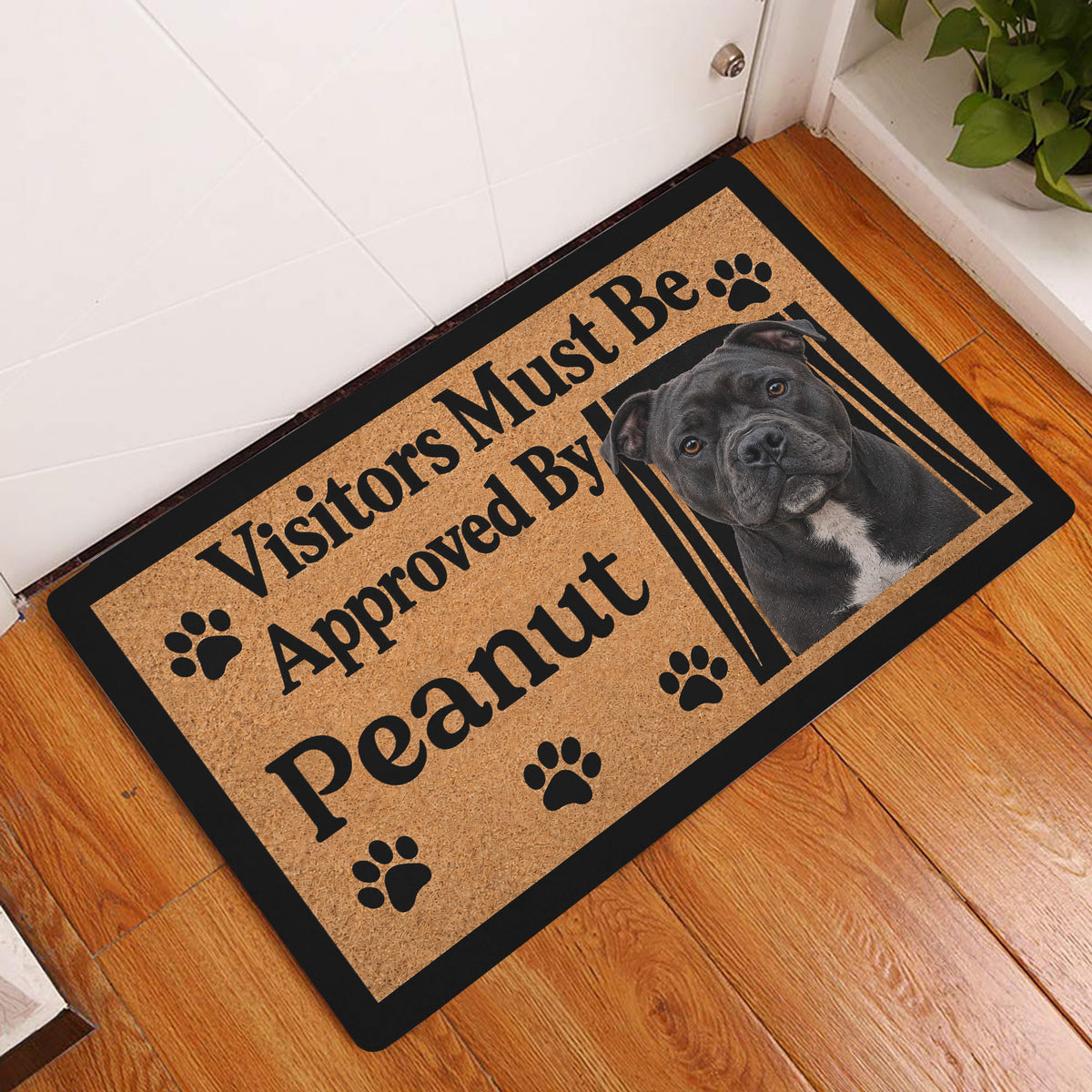 Staffordshire Bull Terrier doormat styled at a home entrance on a warm wood floor