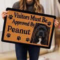 Person holding a Staffordshire Bull Terrier doormat featuring a dog portrait and paw prints