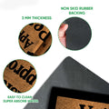 Close-up feature view of the greyhound doormat surface and black rubber backing