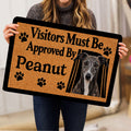 Person holding a greyhound doormat featuring a realistic portrait and playful paw-print design