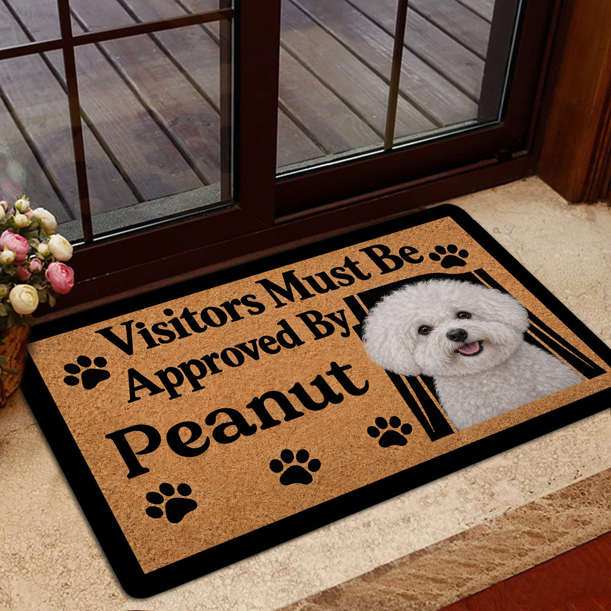 Bichon Frise welcome doormat styled at an indoor entrance with a glass door and warm home decor