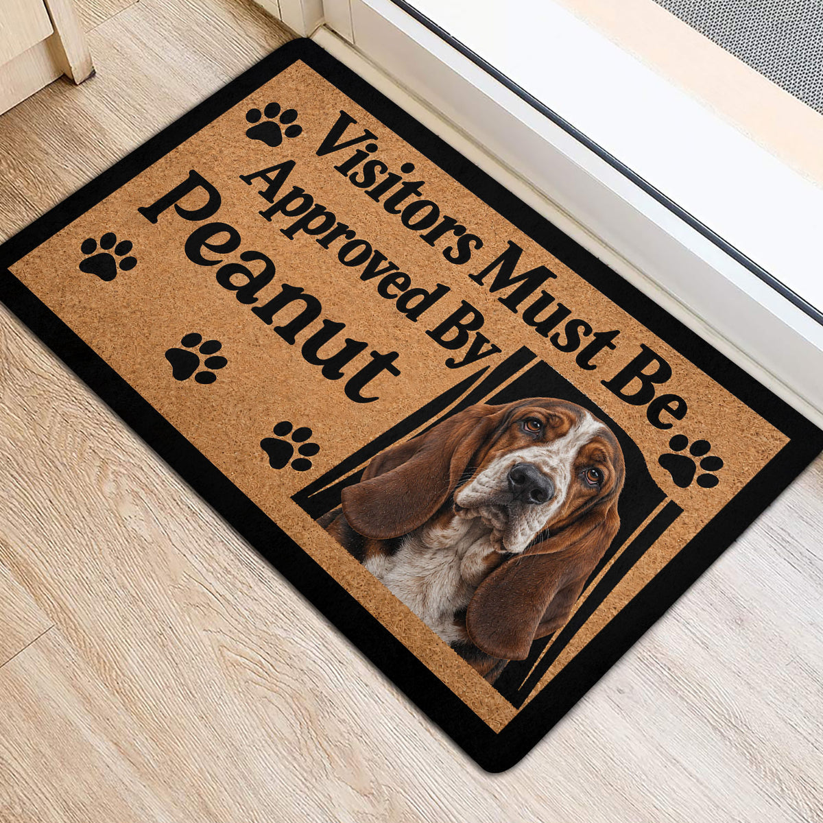 Basset Hound door mat with paw prints and dog portrait positioned inside an entrance