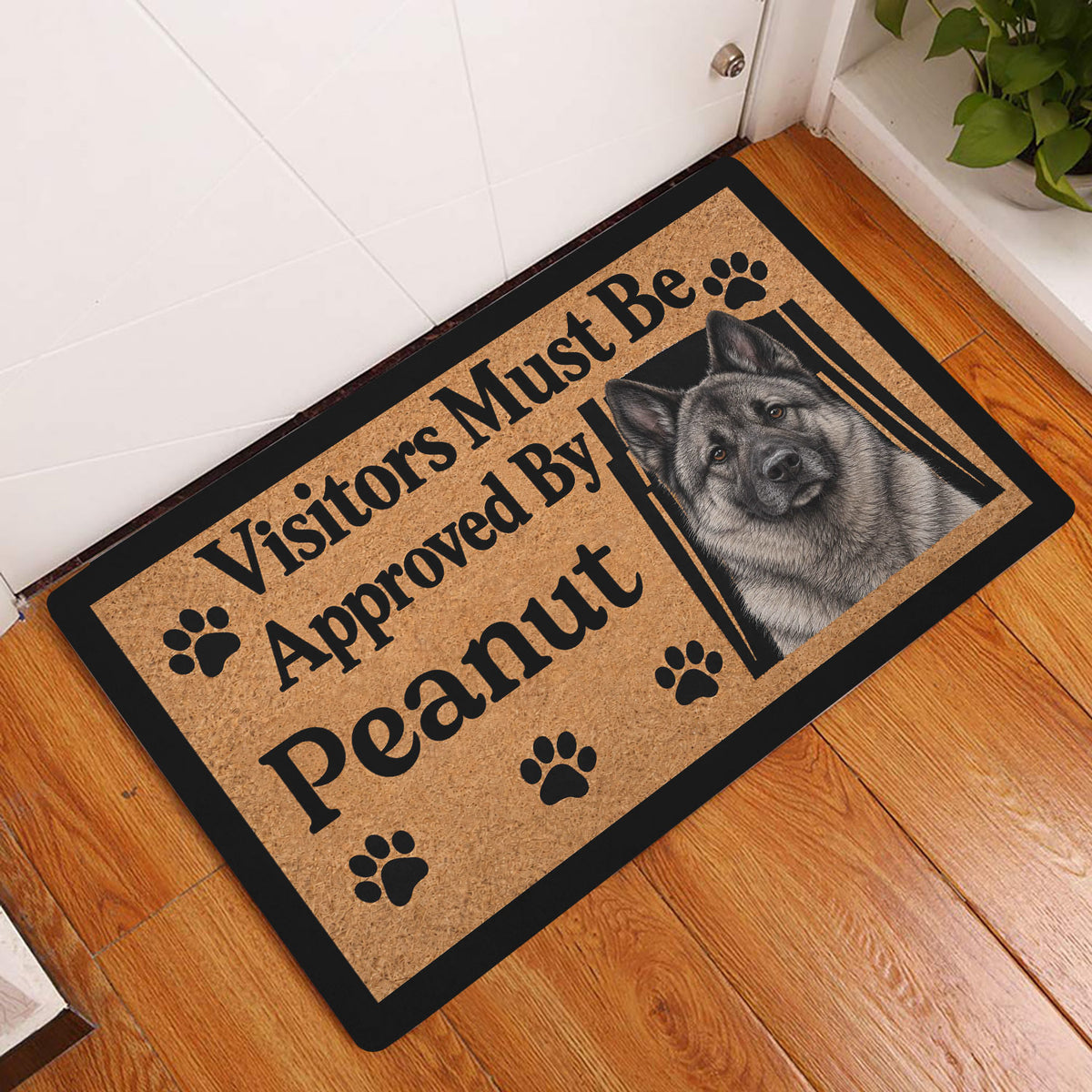 Norwegian Elkhound doormat styled at an indoor entryway beside a white door and wood flooring