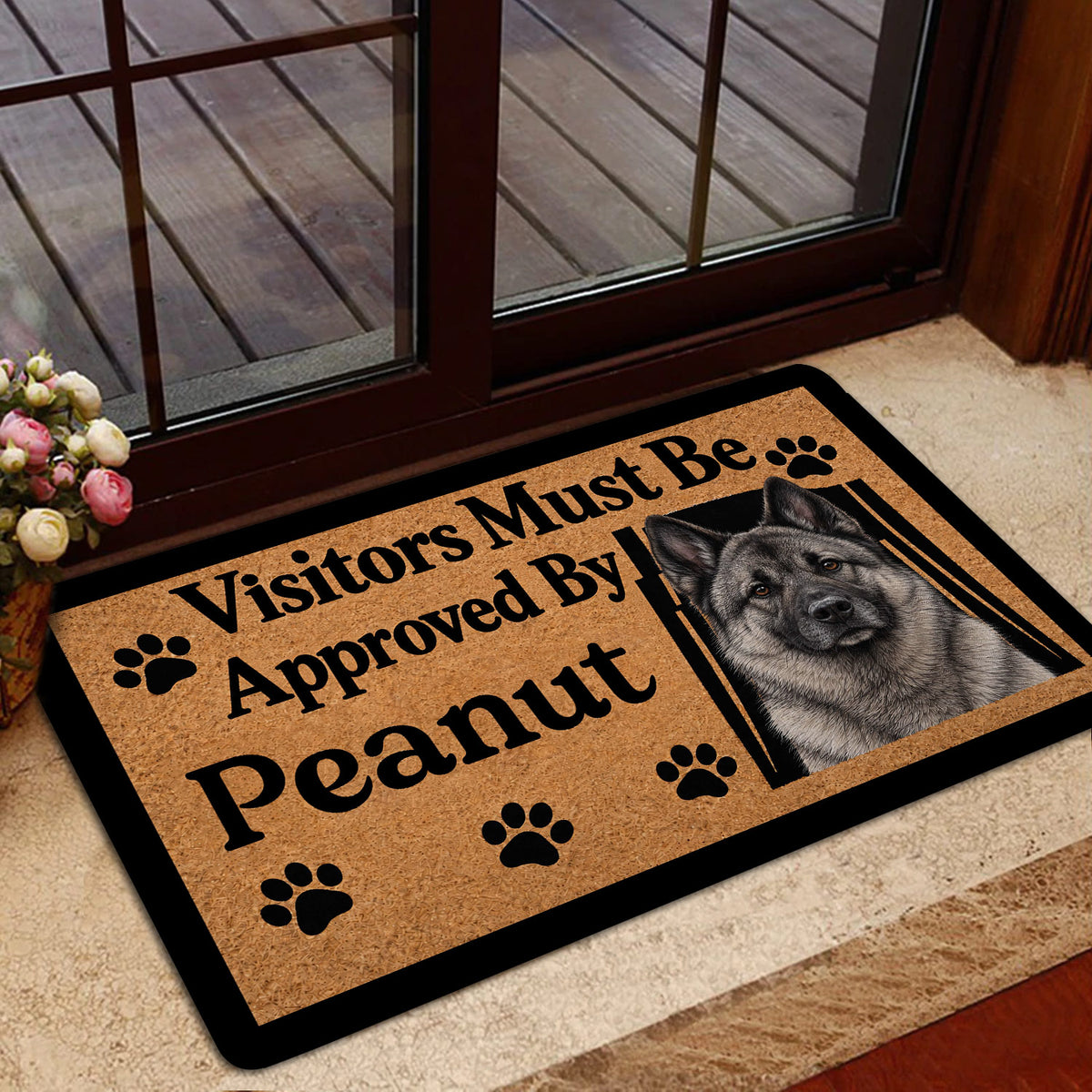 Norwegian Elkhound doormat shown inside a glass doorway with a warm brown design and dog portrait