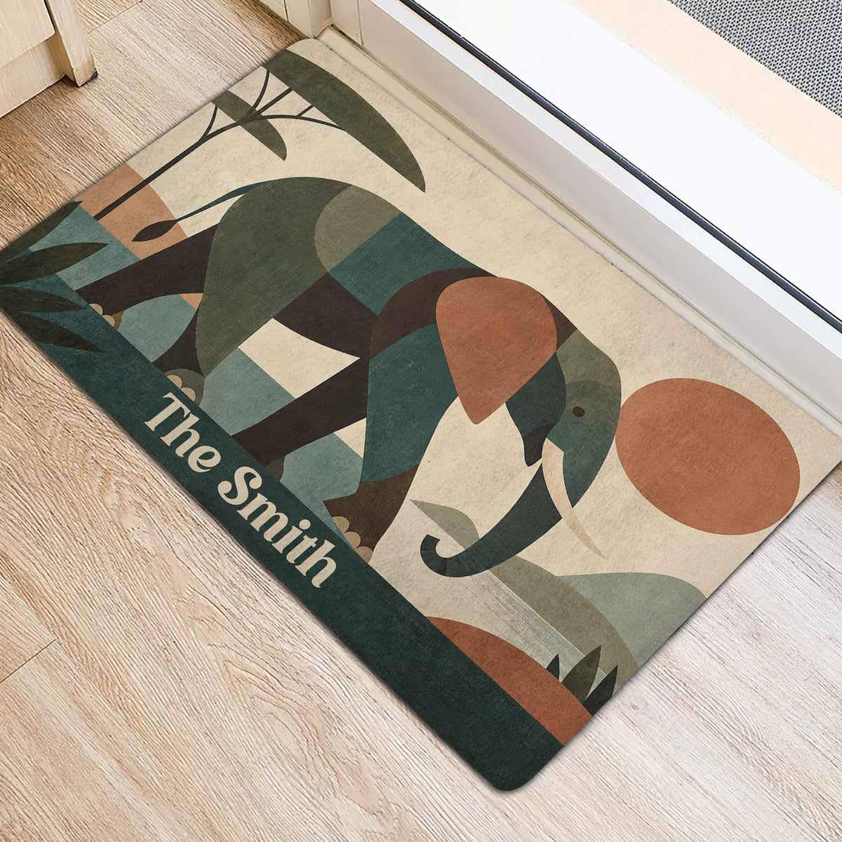 Elephant door mat positioned at an interior doorway, featuring botanical shapes and muted earthy tones