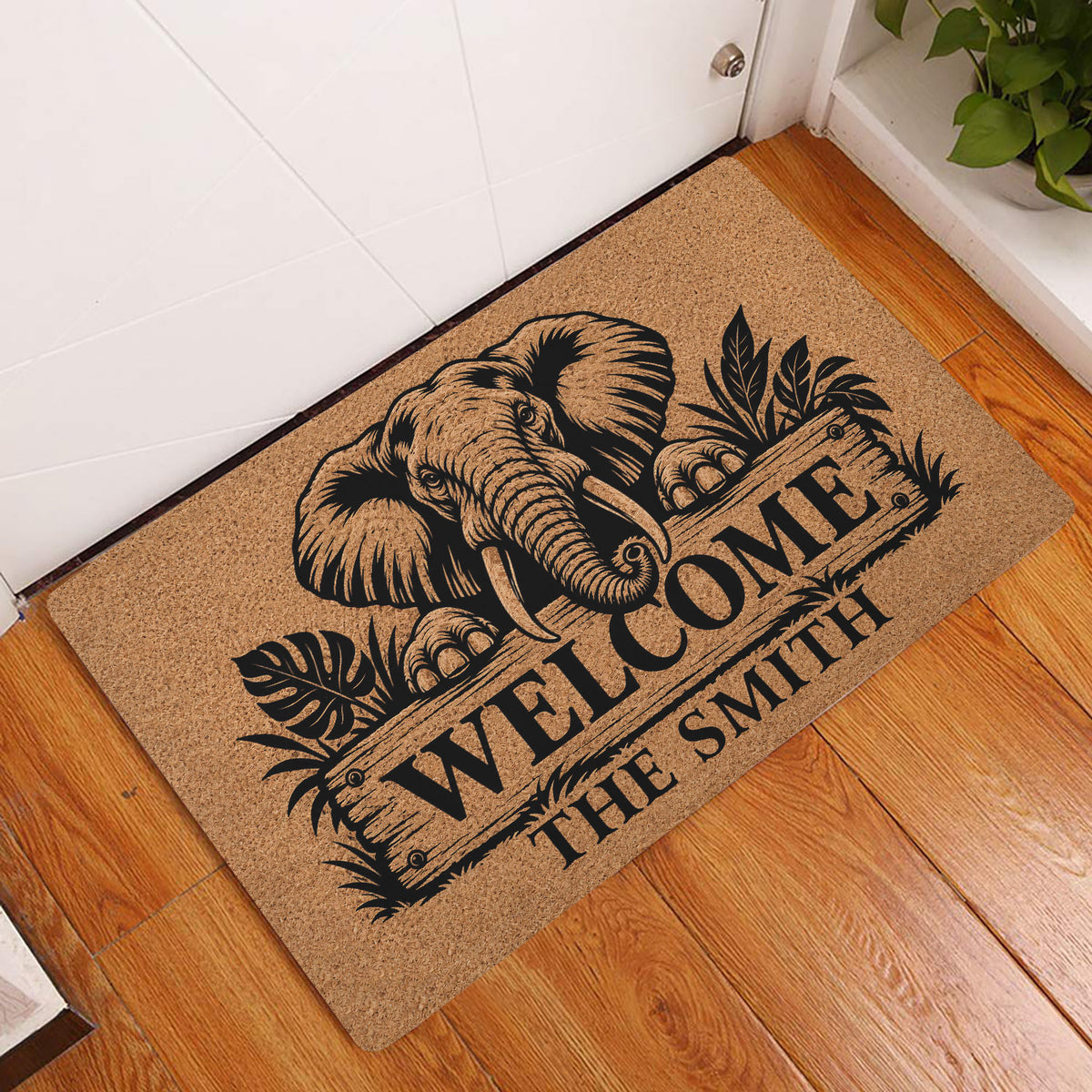 Elephant welcome doormat displayed at a home entrance on warm wood flooring