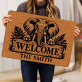 Elephant doormat held indoors, showing detailed wildlife artwork and a welcoming entryway design