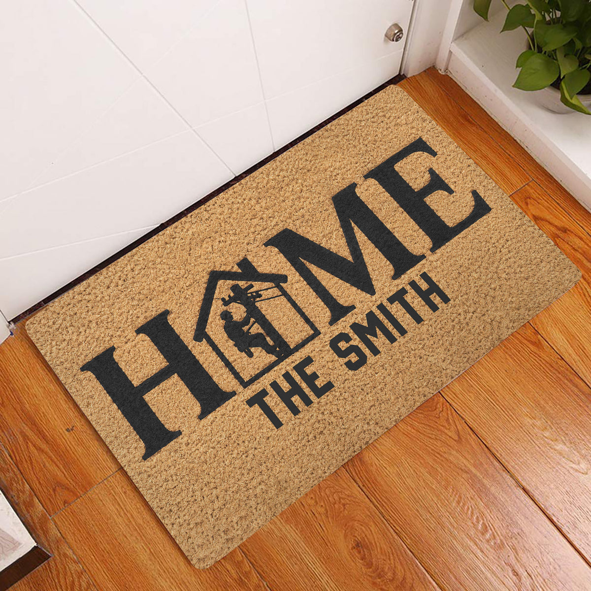 Lineman HOME doormat styled in a warm wood-floor entryway beside a white door