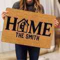 Lineman-themed HOME doormat held indoors, showing the tan surface and bold black artwork