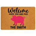 Tan doormat with a playful pink pig silhouette, bold welcome lettering, and humorous pig-themed entryway design