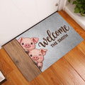 Pig welcome doormat styled at an indoor doorway on a warm wood floor