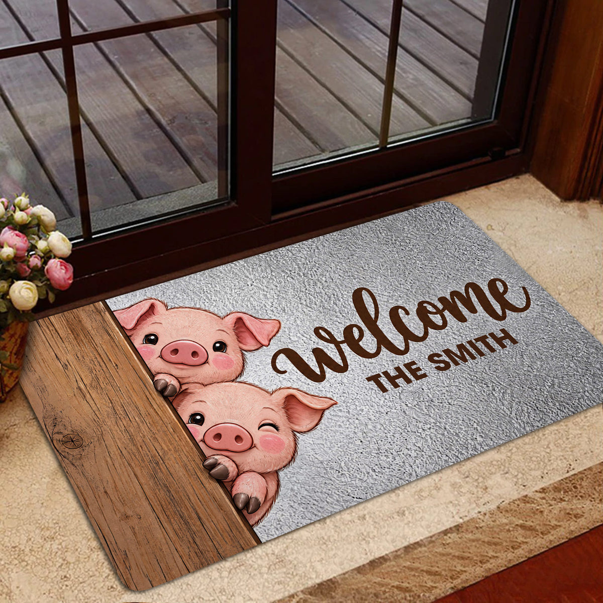 Pig welcome doormat displayed at a glass door entryway with wood accents