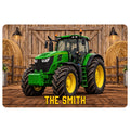 Printed tractor doormat featuring a green farm tractor, barn wood, hay bales, and bold lettering