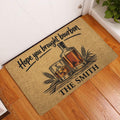 Bourbon bottle and whiskey glass doormat displayed at a home entrance on hardwood flooring