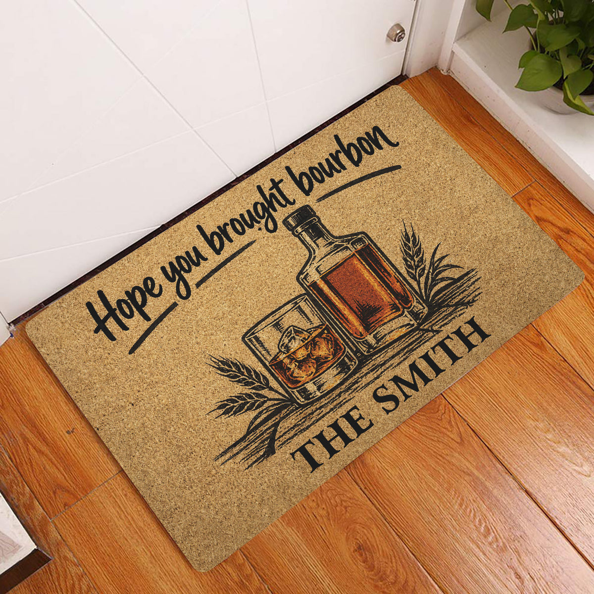Bourbon bottle and whiskey glass doormat displayed at a home entrance on hardwood flooring