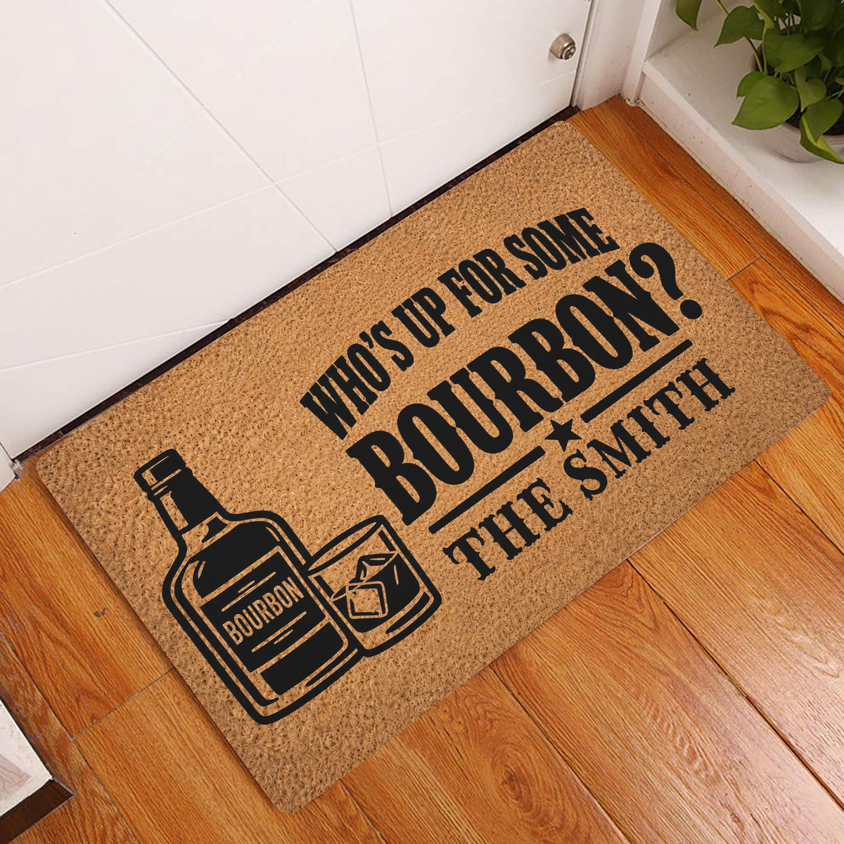 Bourbon doormat styled in a wood-floor entryway beside a white door and indoor plant