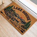 Lake house entryway mat featuring mountain, cabin, canoe and evergreen tree artwork