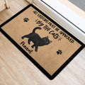 Black cat entryway mat with paw prints and humorous lettering placed near a doorway