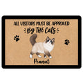 Ragdoll cat doormat with paw prints, tan artwork, black border and playful visitor approval message