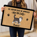 Person holding a Scottish Fold cat doormat featuring paw prints and playful entryway artwork
