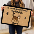 Person holding a Bengal cat doormat showing spotted cat artwork, paw prints, and black border