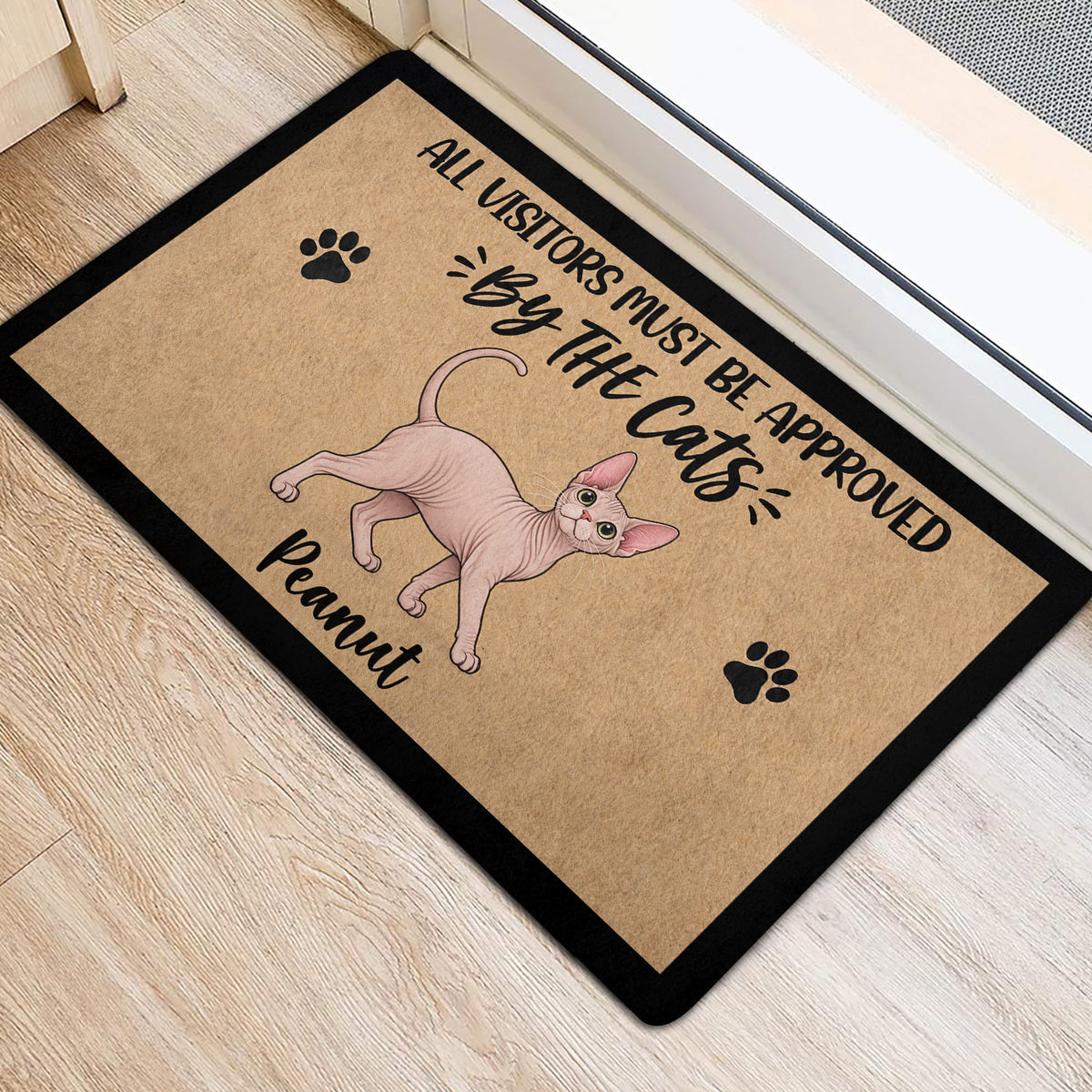 Sphynx cat welcome mat positioned near a doorway on light wood flooring