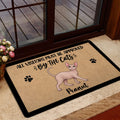 Sphynx cat doormat styled at a home entrance with glass doors and floral decor