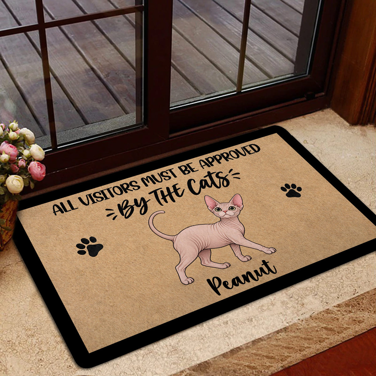 Sphynx cat doormat styled at a home entrance with glass doors and floral decor