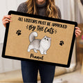 Person holding a Persian cat doormat featuring a fluffy cat illustration, paw prints, and tan artwork