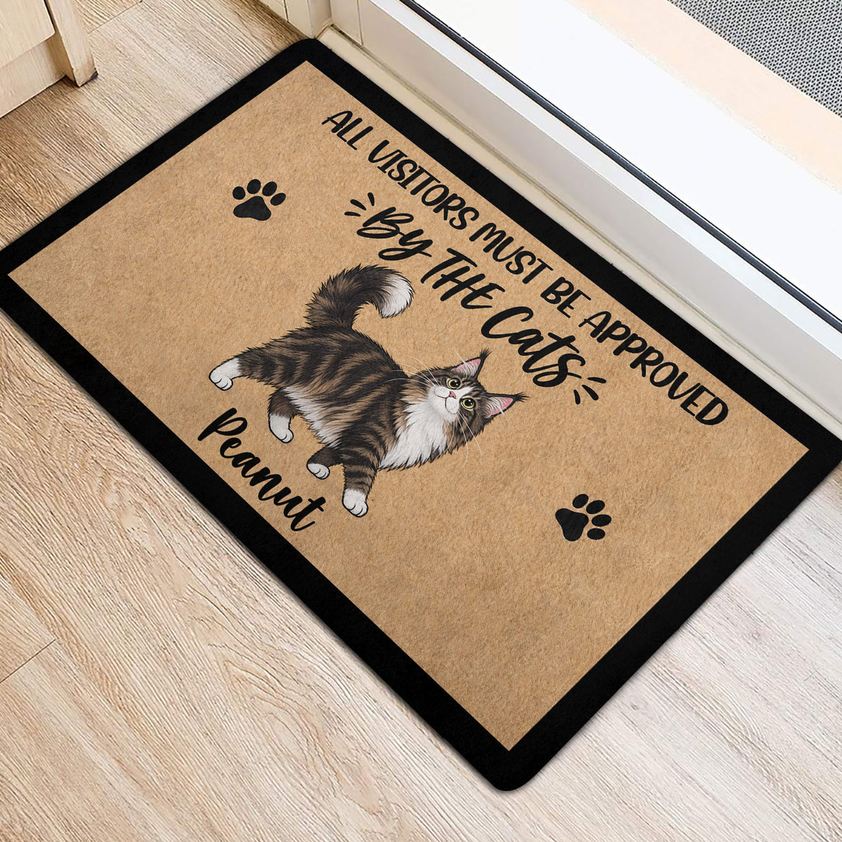 Maine Coon entryway mat featuring a fluffy cat illustration and black paw prints near a doorway