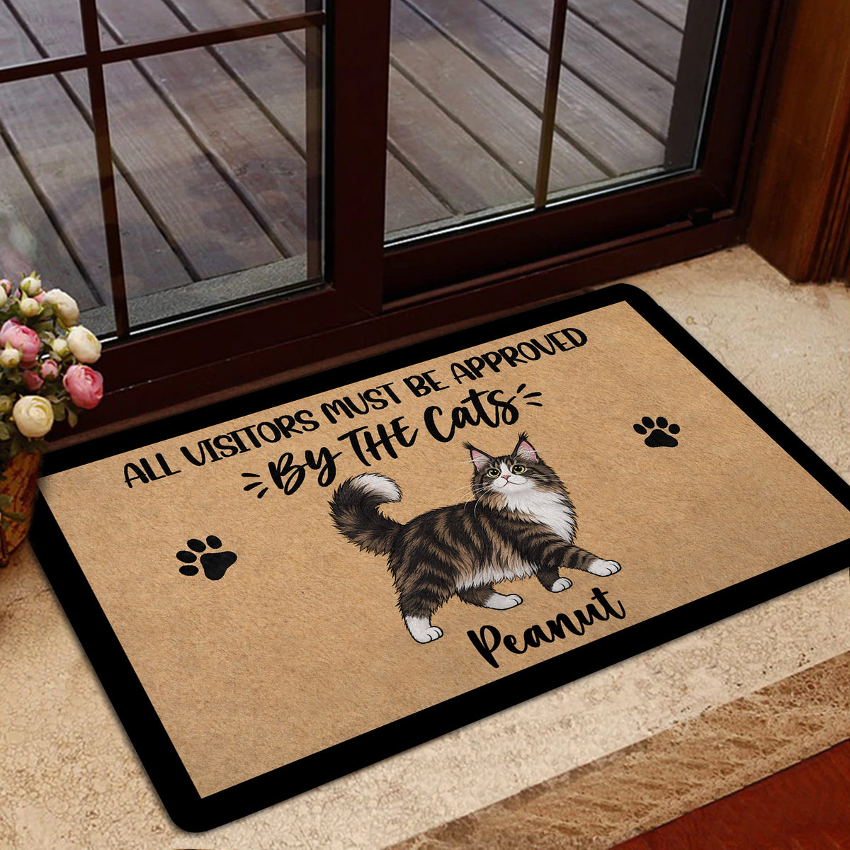 Maine Coon doormat displayed beside a glass entry door with flowers and home decor