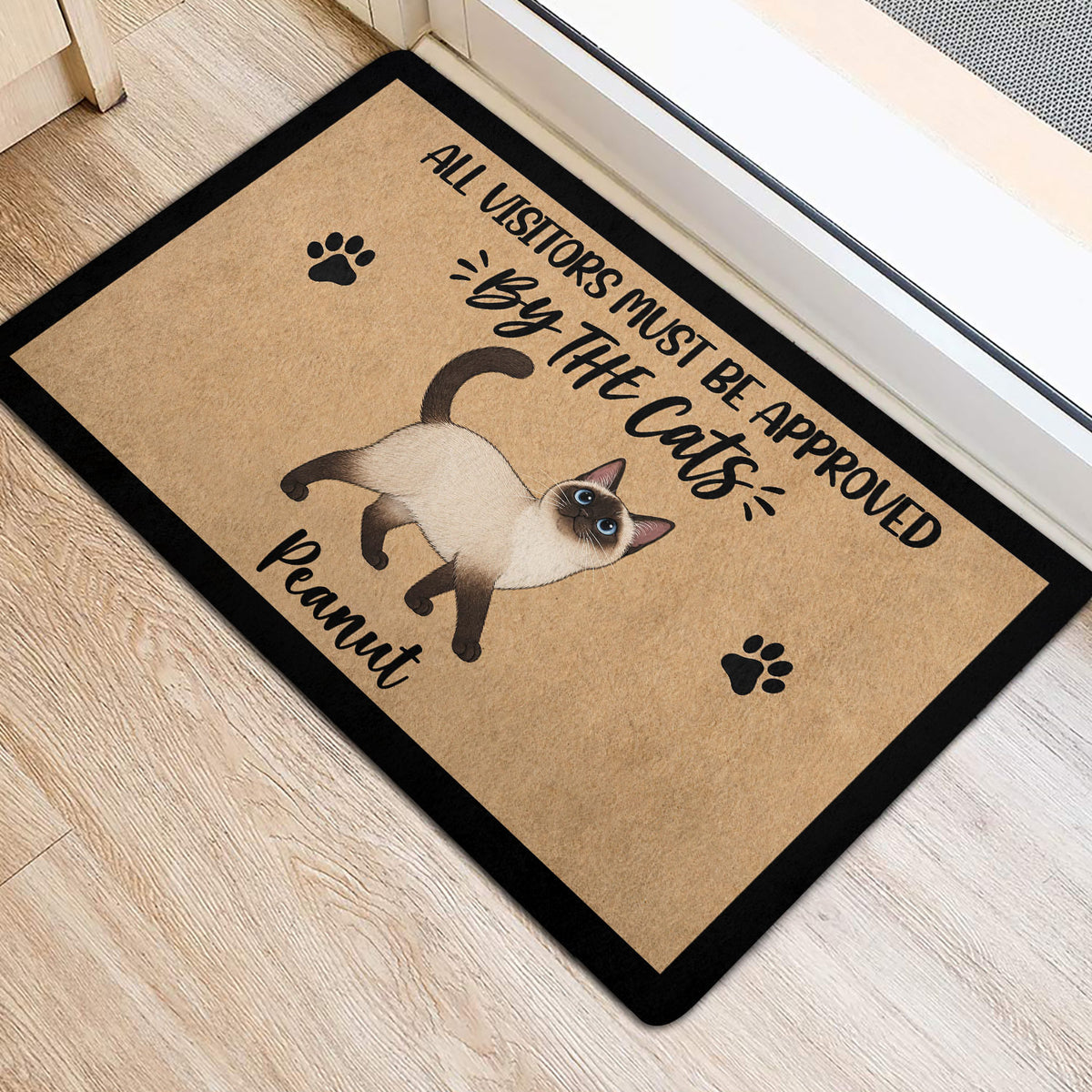 Siamese cat rug positioned near an interior doorway with paw print accents