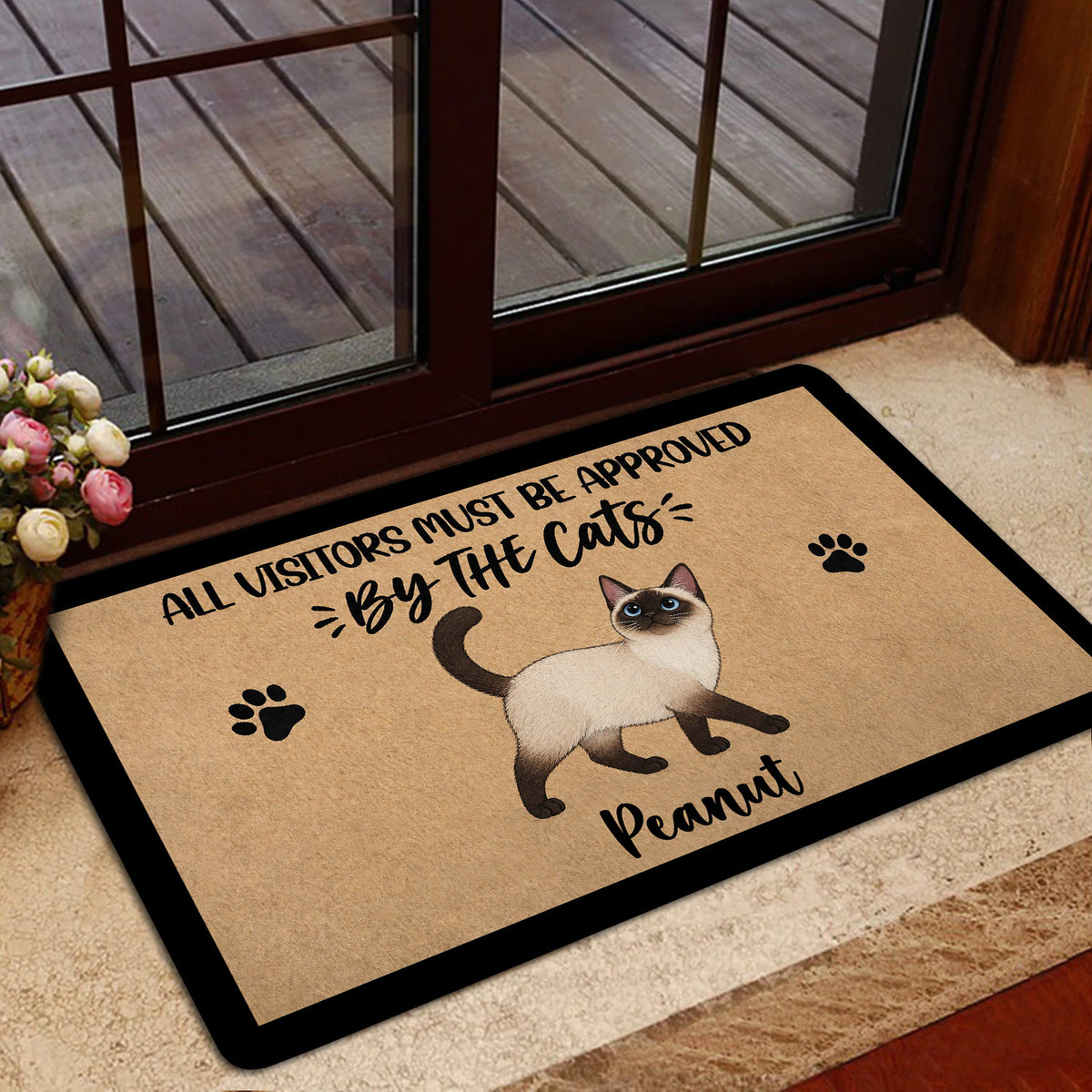 Siamese cat doormat styled in a home entrance beside a glass door