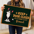 Tuxedo cat doormat held indoors, showing the full dark green design and humorous cat-themed artwork
