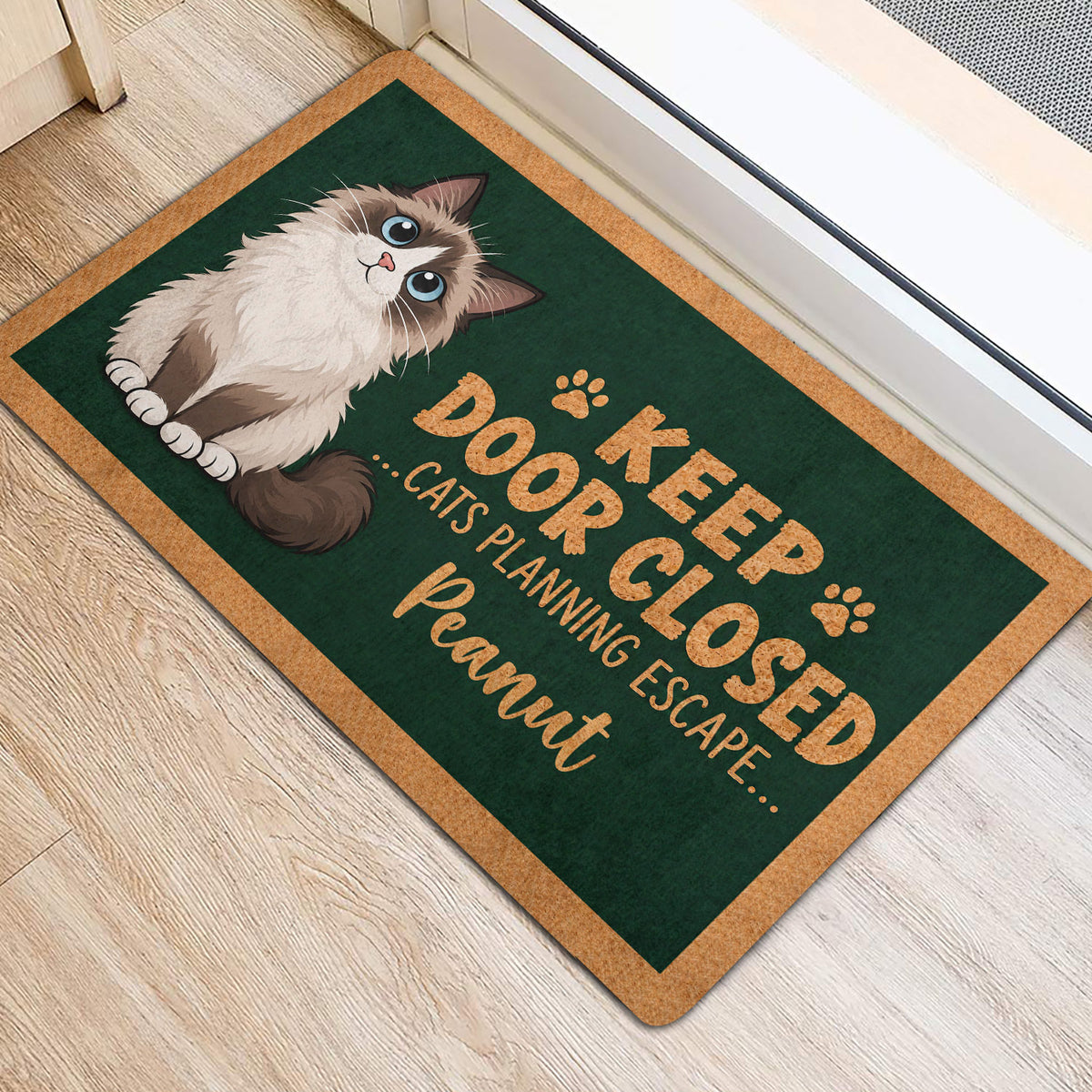 Ragdoll cat entryway rug displayed beside a doorway with a green and tan design