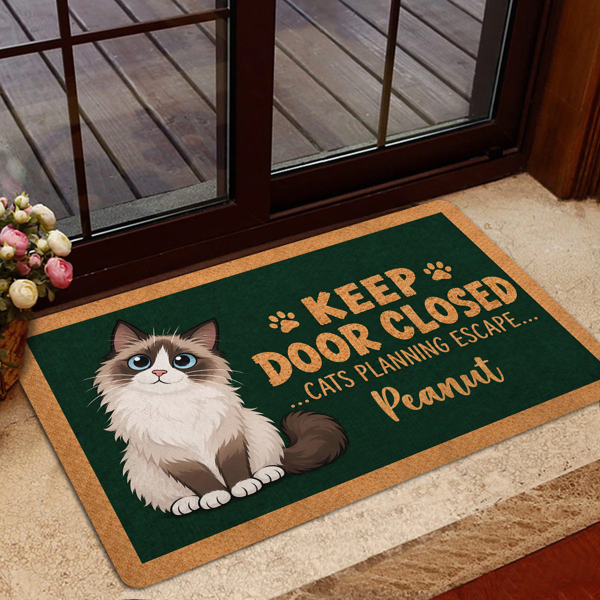 Ragdoll cat doormat positioned near a glass door in a welcoming home entryway