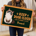 Person holding a Ragdoll cat doormat featuring a fluffy blue-eyed cat and paw print artwork
