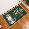 Scottish Fold cat entryway mat displayed beside a white door on a warm wood floor