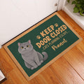British Shorthair cat doormat styled by a white door on a warm wood floor
