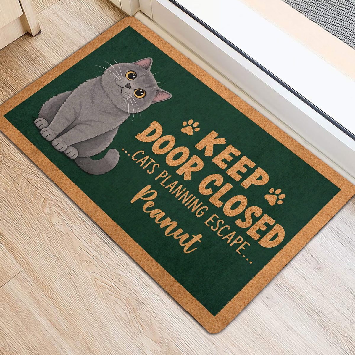 Gray British Shorthair cat rug displayed near a doorway with dark green artwork and paw prints