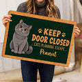 British Shorthair cat doormat held indoors, showing the full green artwork and tan border