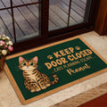 Bengal cat doormat styled by a glass door with a dark green illustrated design