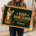 Bengal cat doormat held indoors, showing the spotted cat illustration and paw prints