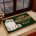 Persian cat doormat styled at a glass patio door with a fluffy cat illustration