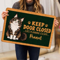 Maine Coon cat doormat held indoors, showing the full dark green design and tan border