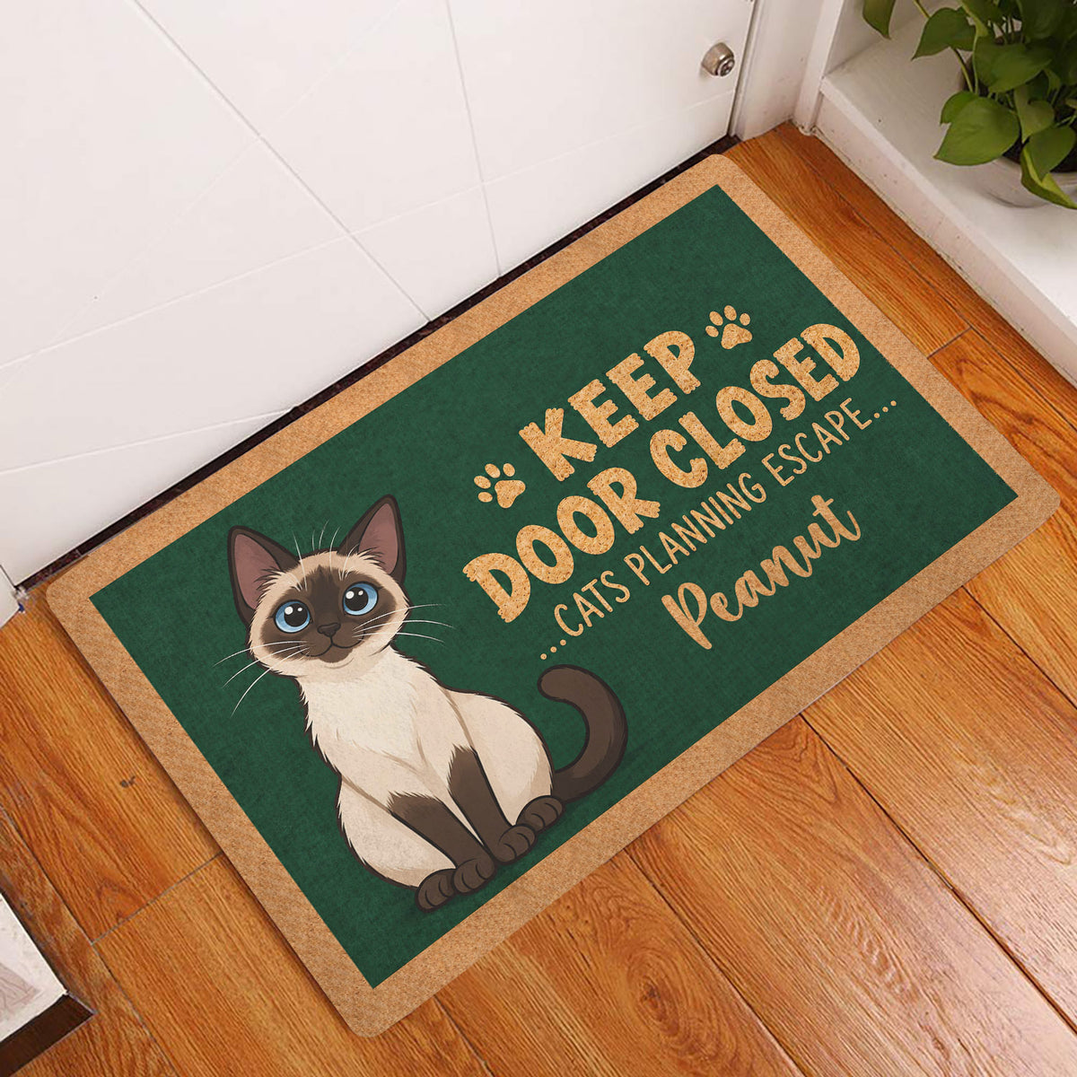 Siamese cat entryway mat displayed by a white door on a warm wood floor