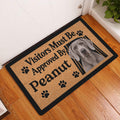 Weimaraner doormat displayed in a home entryway on a wood floor beside a door