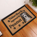 Whippet doormat styled in an indoor entryway beside a white door and wood flooring