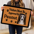 Person holding a Whippet doormat featuring a dog portrait, paw prints, and playful typography